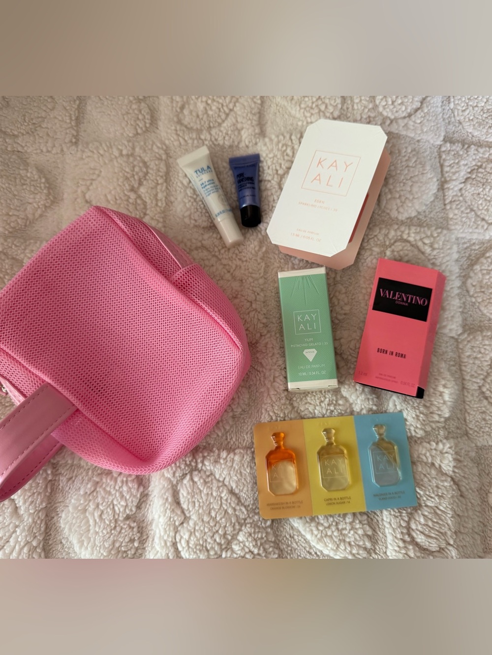 KAYALI Yum Pistachio Gelato Eau de Parfum - Green and a pink cosmetic bag